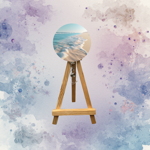 Beach badge pulls with glitter options displayed on a wooden easel against a colorful background.