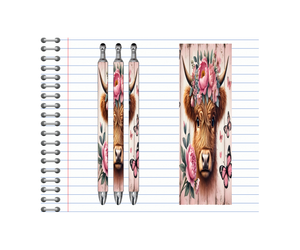 Highland cow refillable pens with floral designs and butterflies on a lined notepad background.