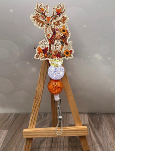 Patchwork deer badge reel with glitter background and autumn colors, perfect for fall-themed accessories.