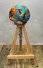 Hummingbird badge pulls featuring vibrant hummingbird with floral details on a wooden easel.