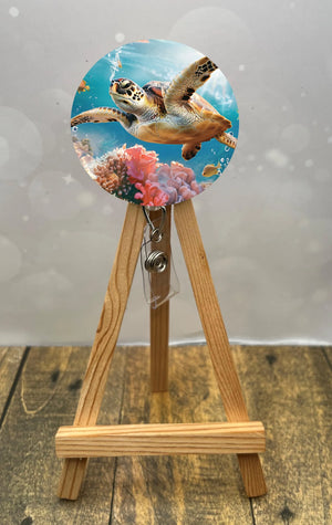 Sea turtle badge pulls featuring a vibrant turtle design with coral background, perfect for ID badges.