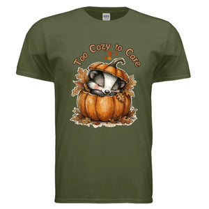 Too Cozy graphic tee for fall featuring a badger asleep in a pumpkin on military green fabric.