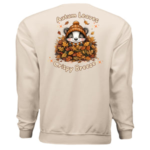 autumn leaves graphic sweatshirt featuring a raccoon in leaves with the text 'Autumn Leaves Crispy Breeze' on the back.