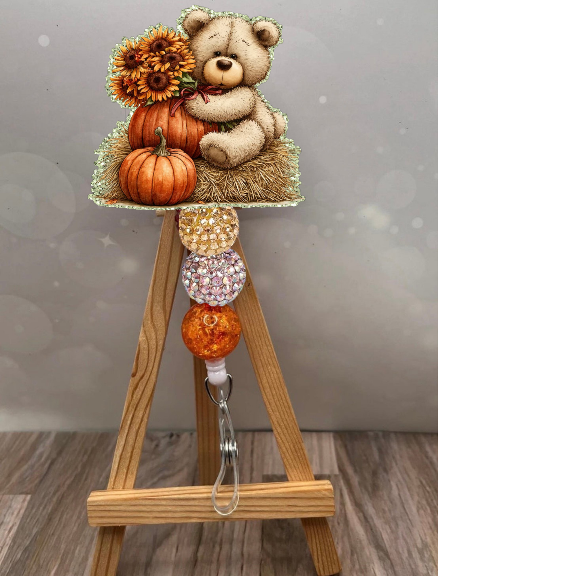 Fall bear badge reel featuring a cute bear with pumpkins and sunflowers, set against a sparkling sage glitter background.