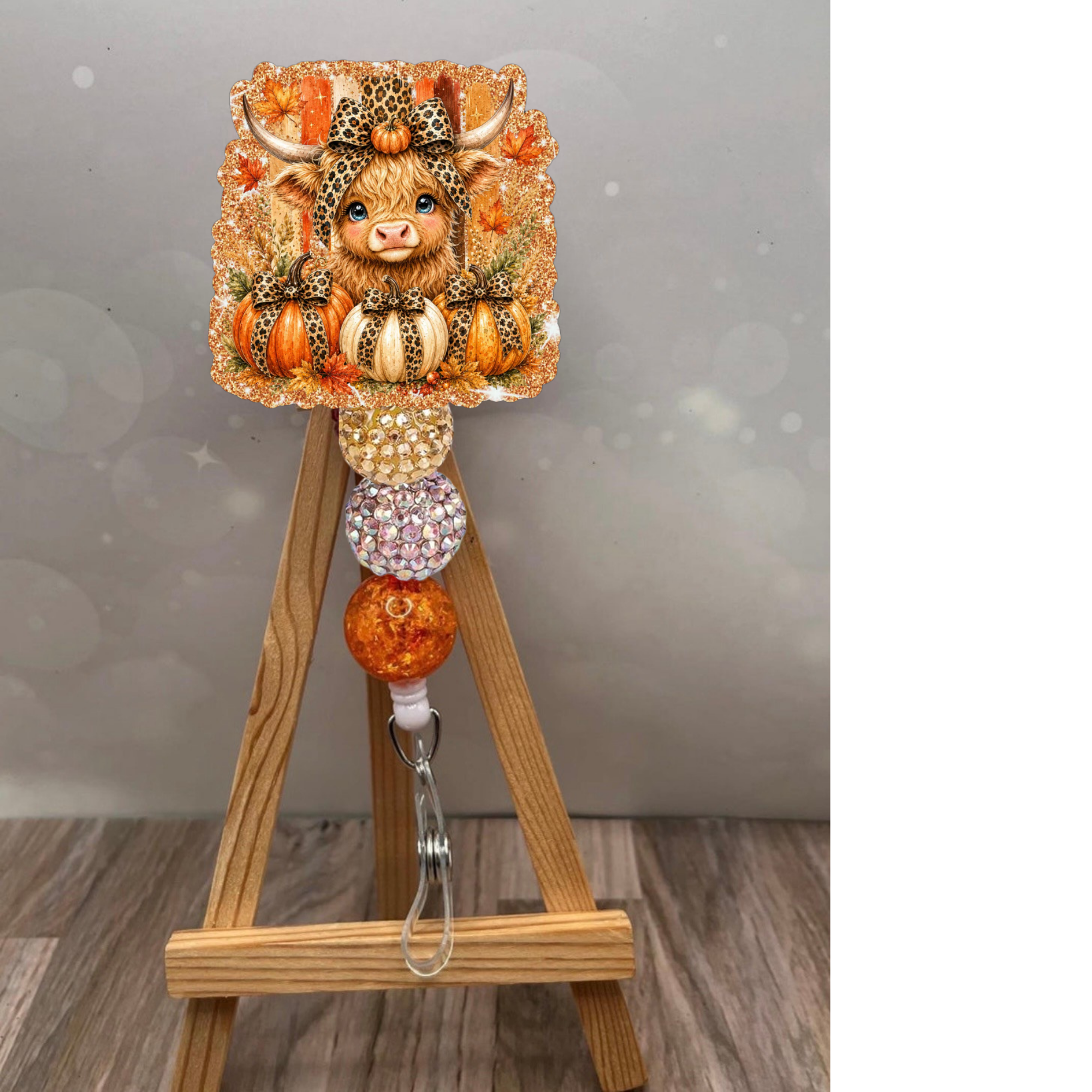 Fall Highland Cow Badge Pull with orange glitter background and cute Highland cow design.