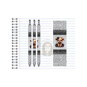 Highland cow refillable pens displayed on lined notebook, featuring cute designs for charming writing.