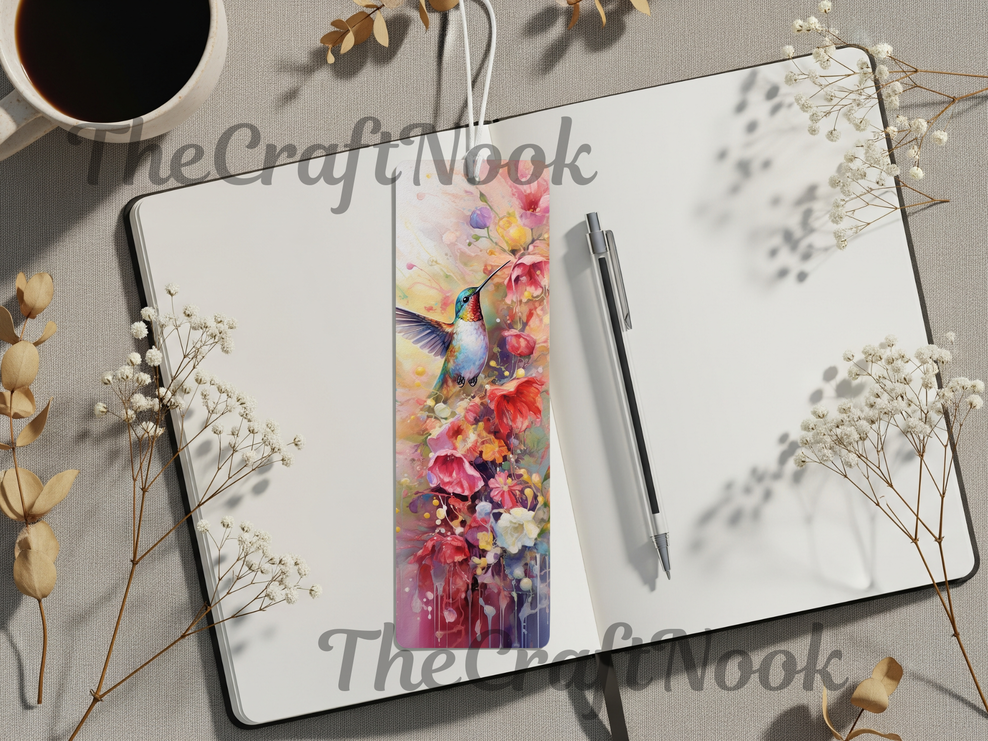 Hummingbird aluminum bookmarks displayed on a notebook with flowers, featuring vibrant colors and floral details.