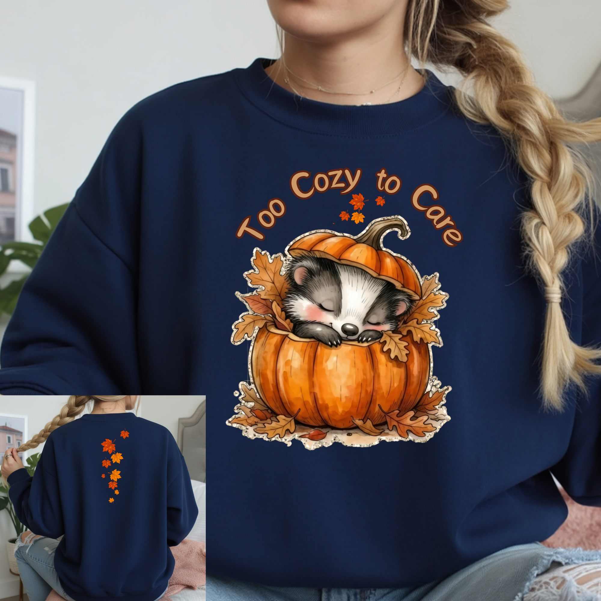 Cozy long sleeve graphic tee featuring a cute raccoon in a pumpkin design on the front and autumn leaves on the back.