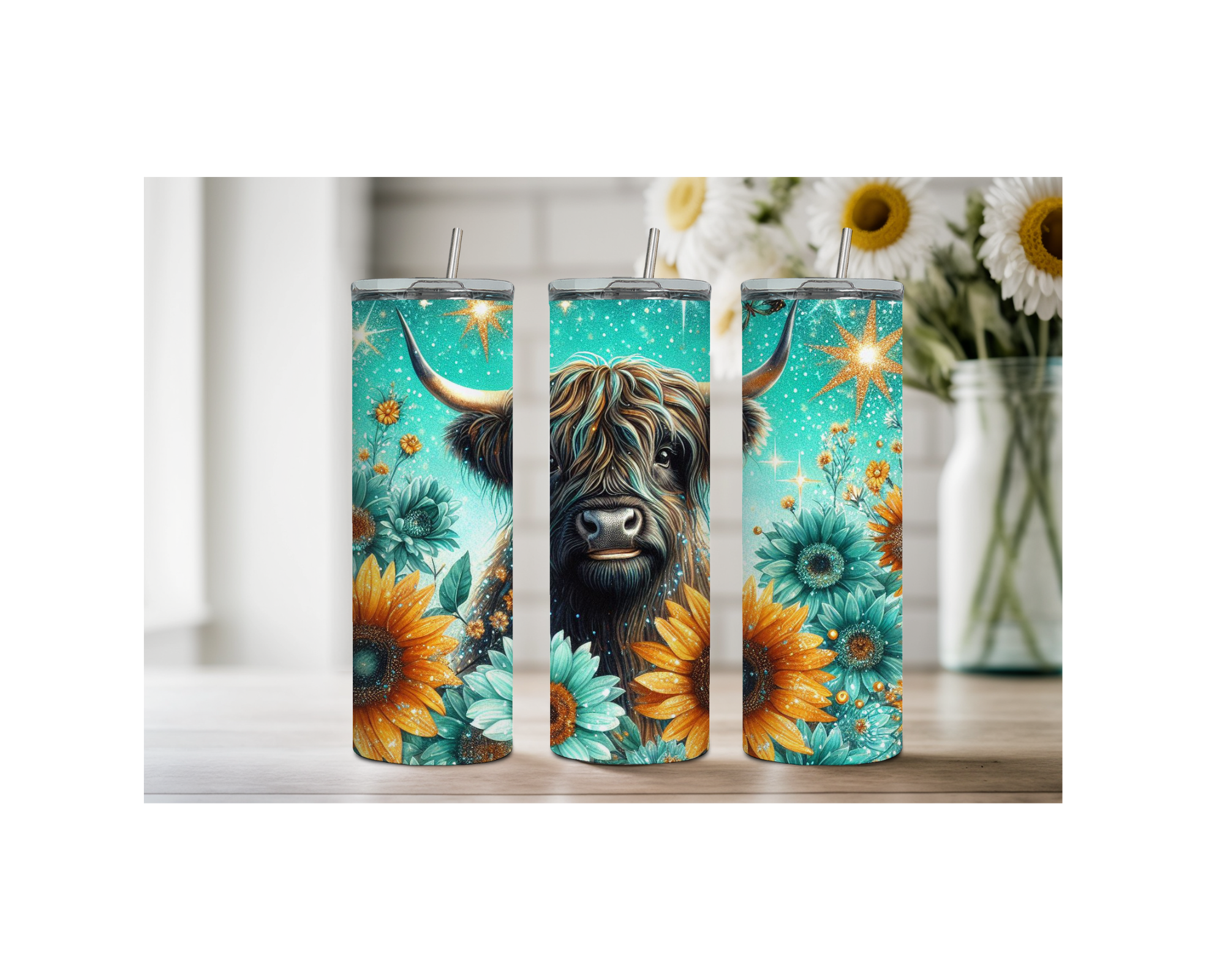 Highland cow stainless steel tumbler trio with sunflower and floral designs on a kitchen countertop.