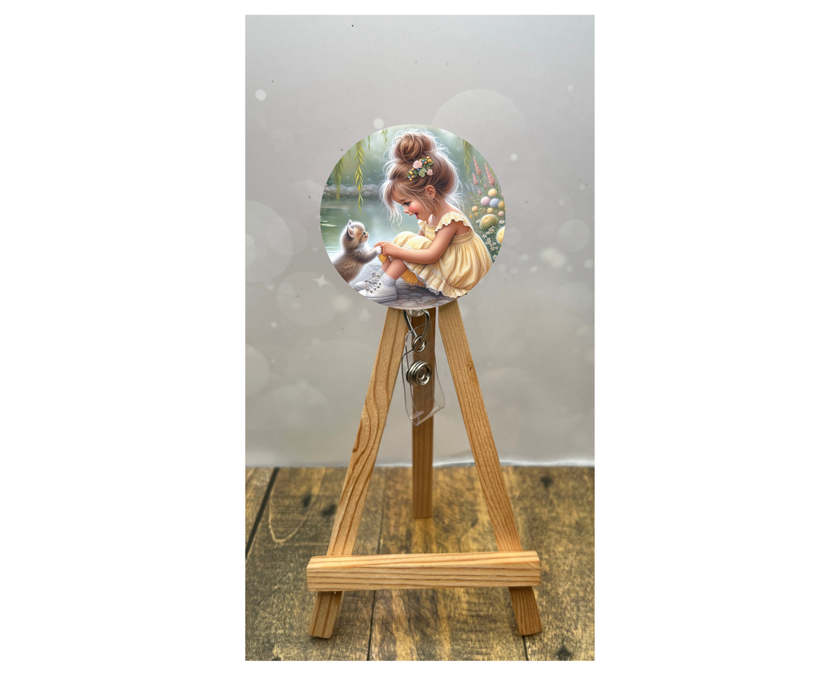 Cat badge pulls for nurses featuring a cute girl illustration on an easel display.