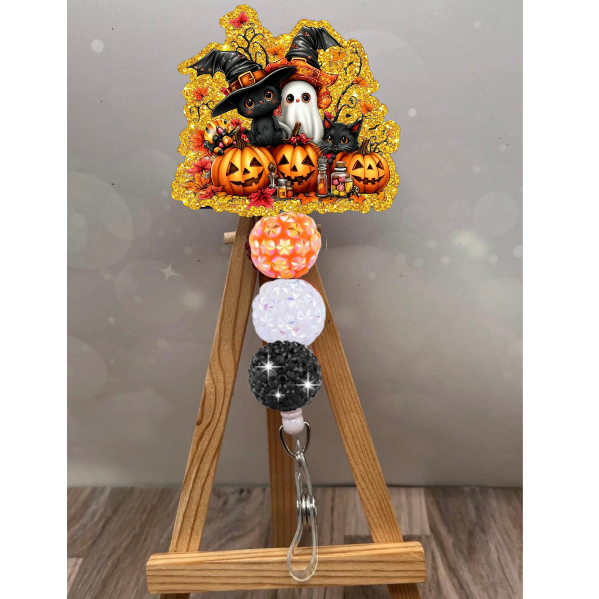Pumpkin patch badge reel featuring Halloween characters and colorful beads, perfect for fall gatherings.