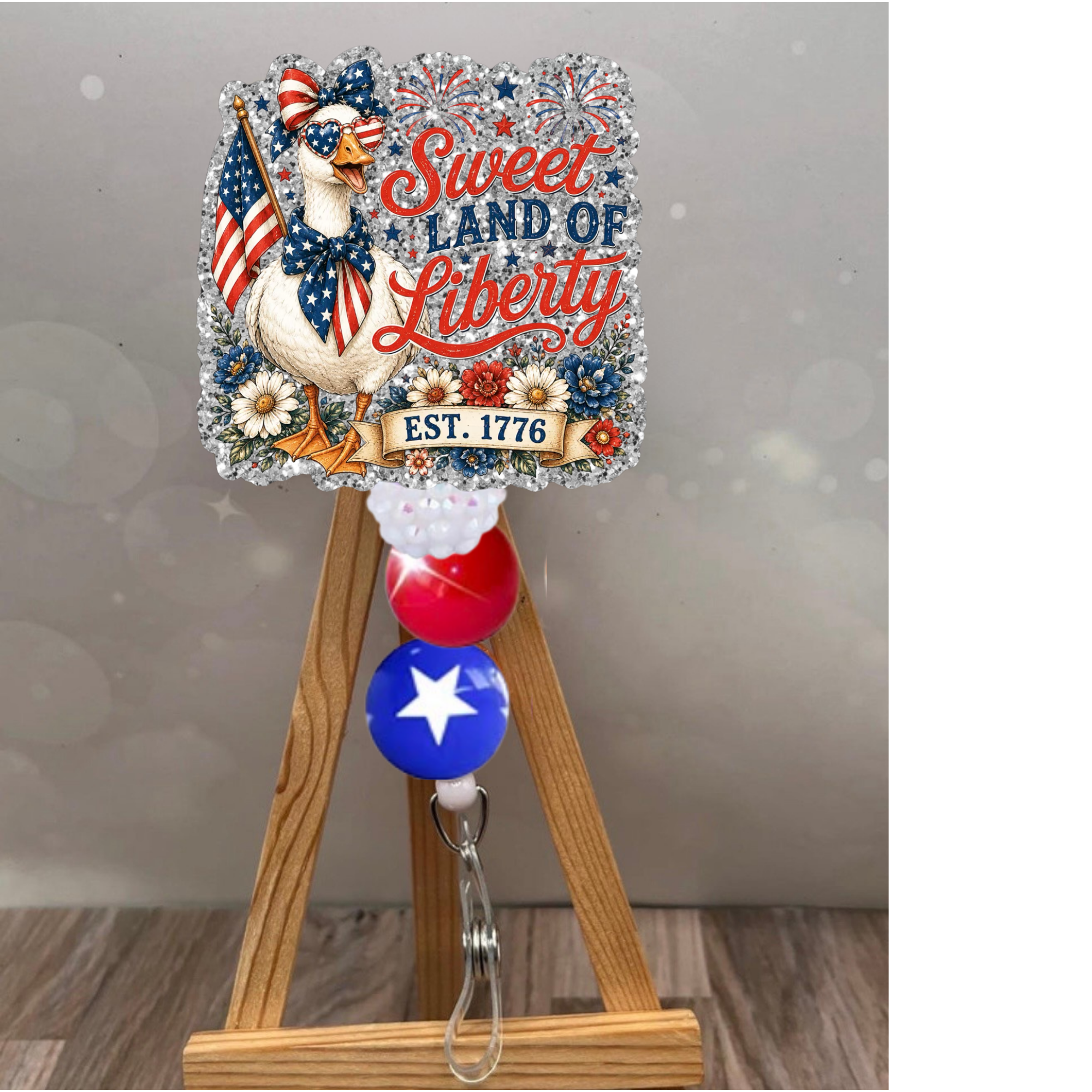 Sweet Land of Liberty patriotic badge reel with glitter background, featuring a festive design for proud Americans.