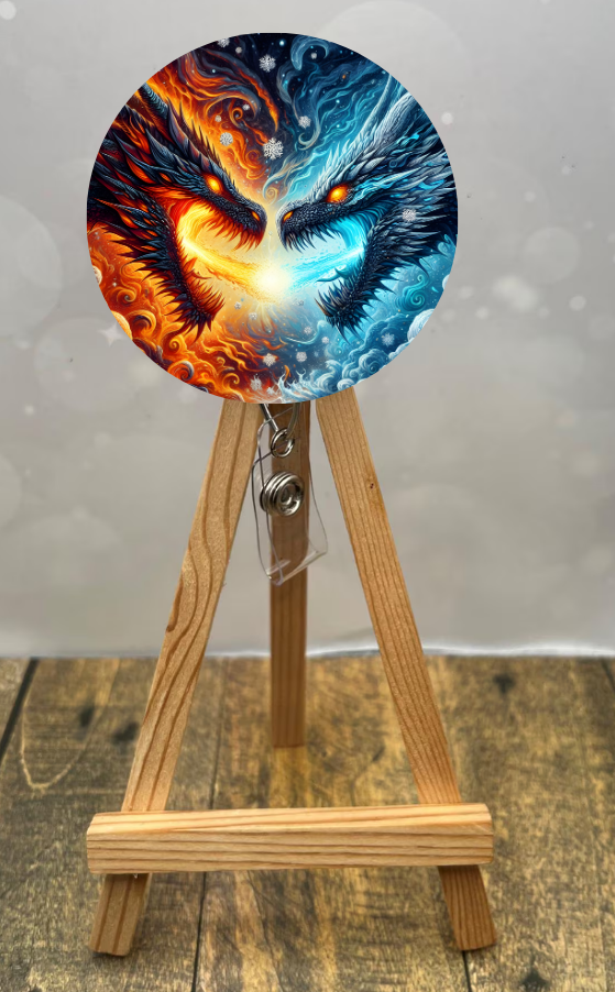 Dragon badge pull reel featuring vibrant dragon artwork, showcasing fiery and icy designs on a wooden stand.