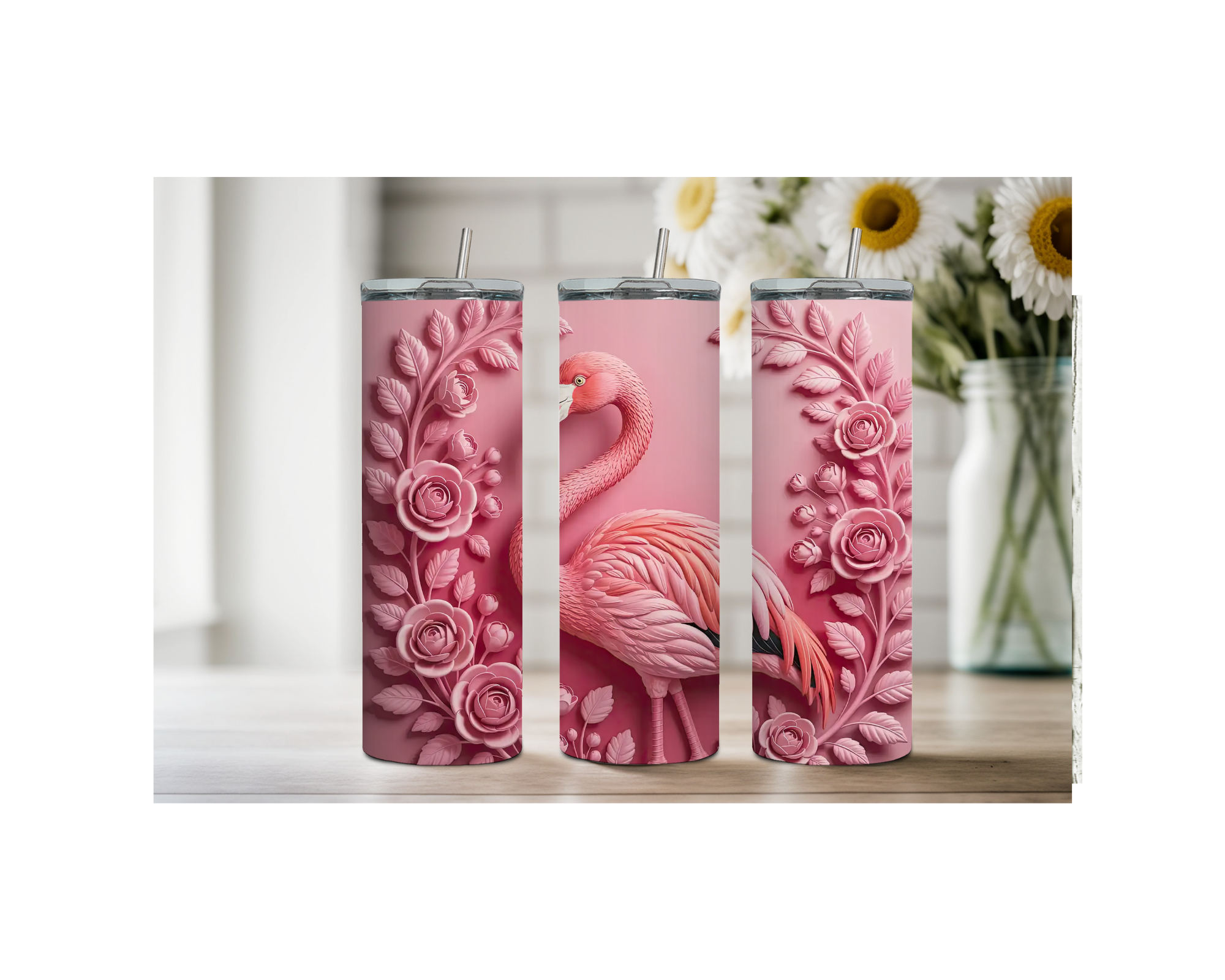 Three pink flamingo stainless steel tumblers with floral designs, perfect for tropical-themed drinks.
