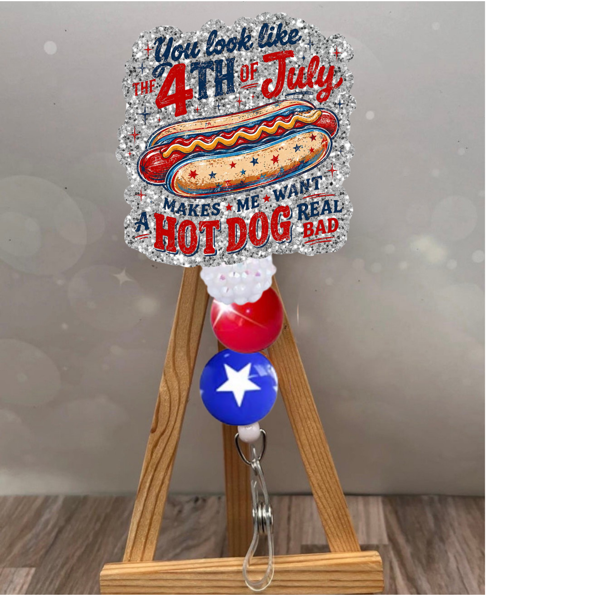 4th of July badge pull featuring a hot dog design and festive glitter background, perfect for summer celebrations.