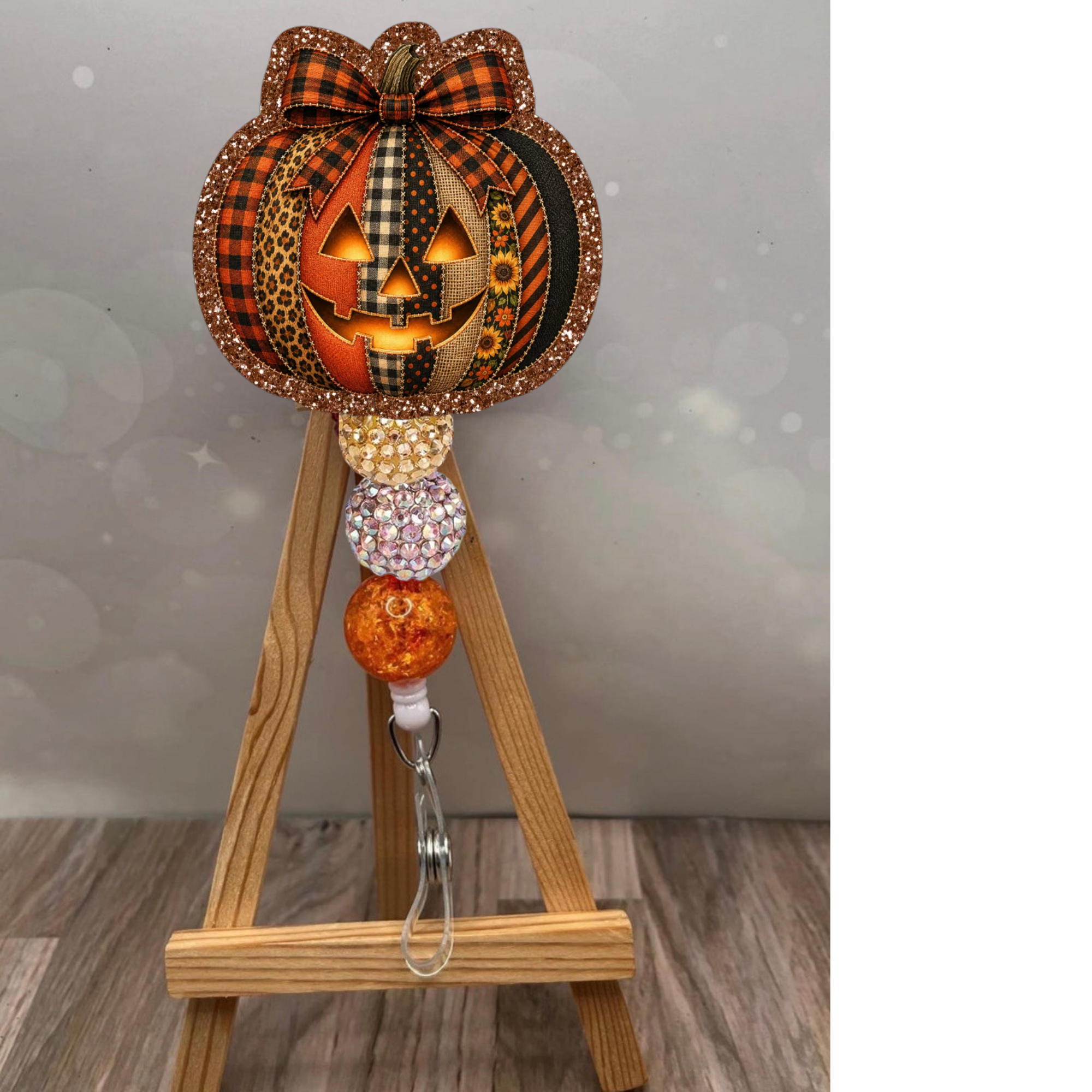 Patchwork Jack-O-Lantern Badge Pull with glitter background, perfect for Halloween-themed lanyards, jack-o-lantern badge reel.