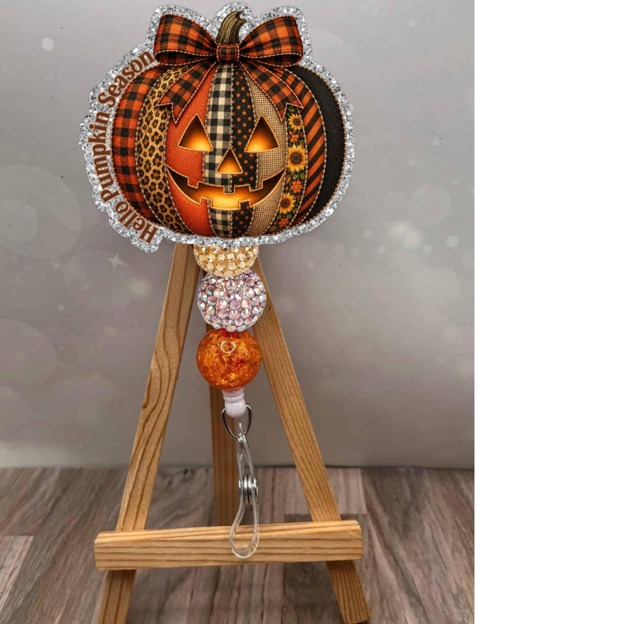Hello Pumpkin Season Badge Pull with glitter background, featuring a festive pumpkin design, perfect pumpkin badge reel for fall.