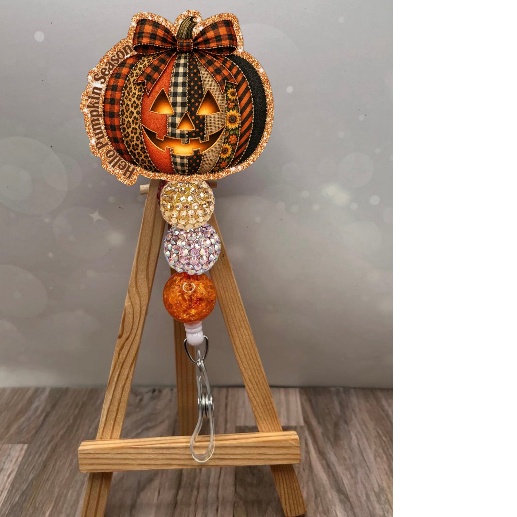 Hello Pumpkin Season Badge Pull featuring a sparkling pumpkin design and glittery beads, perfect for fall enthusiasts. pumpkin badge reel.
