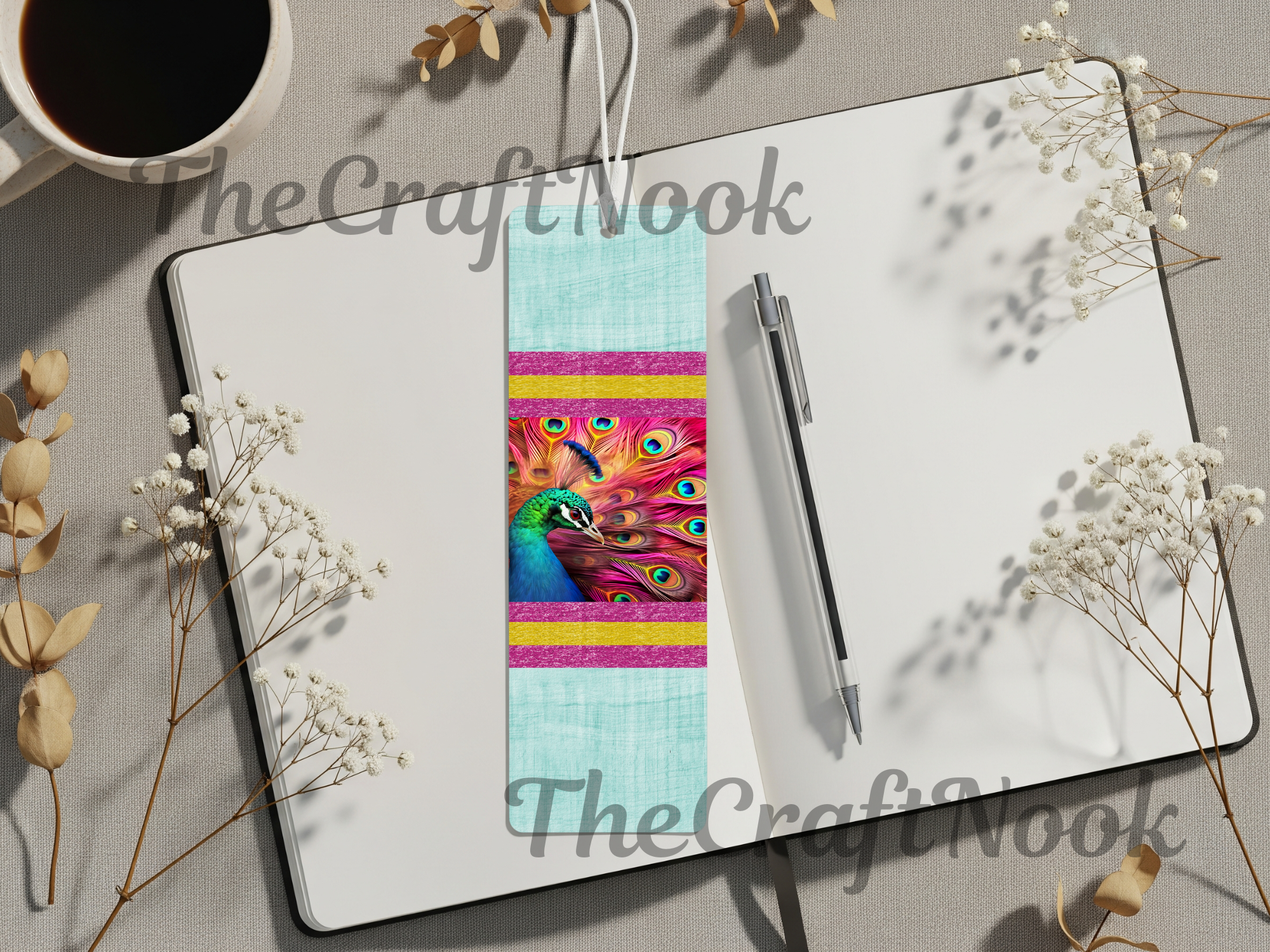 Aluminum peacock bookmarks featured on a notebook with floral accents and a coffee cup.