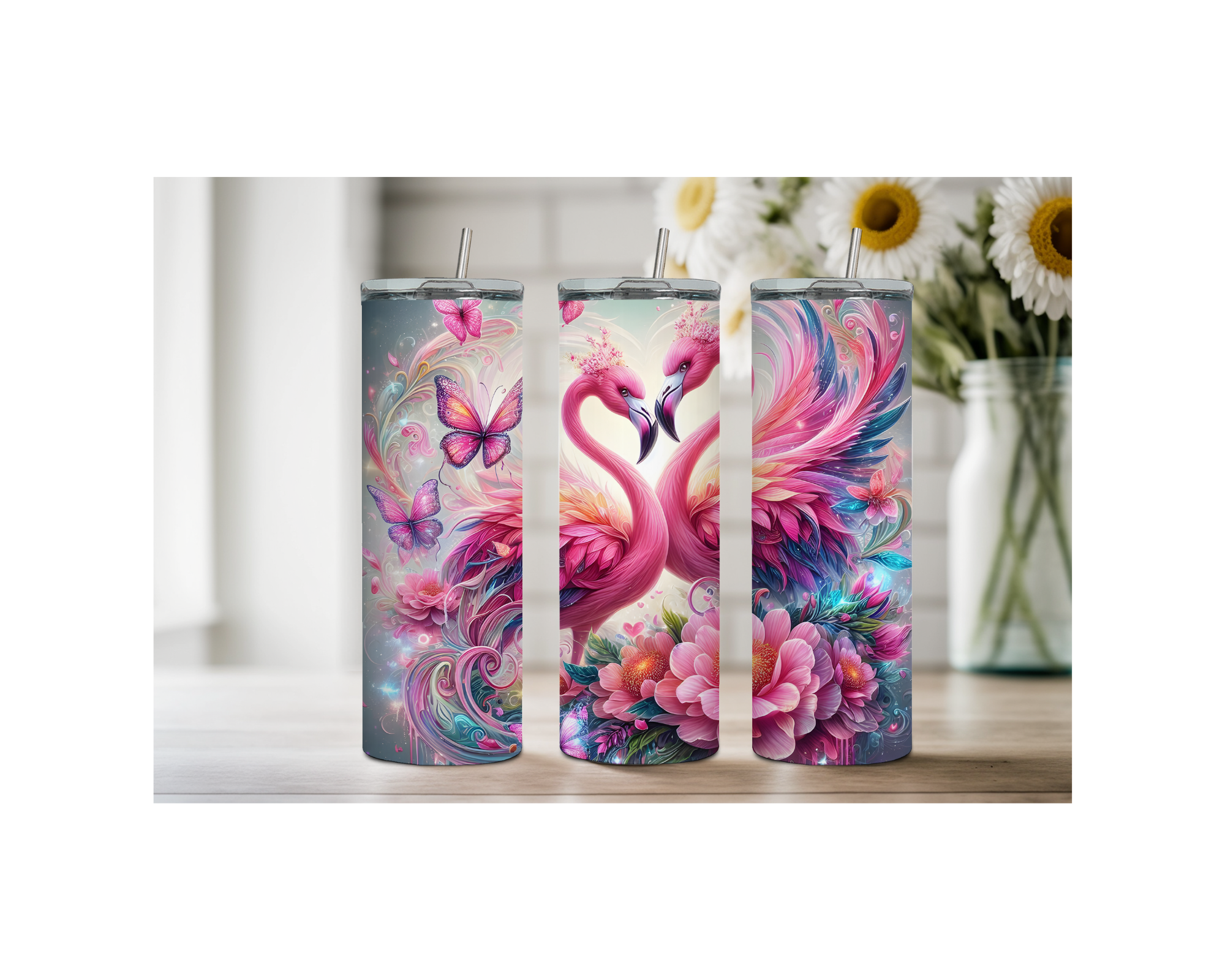 Three pink flamingo stainless steel tumblers with vibrant artwork featuring flowers and butterflies.