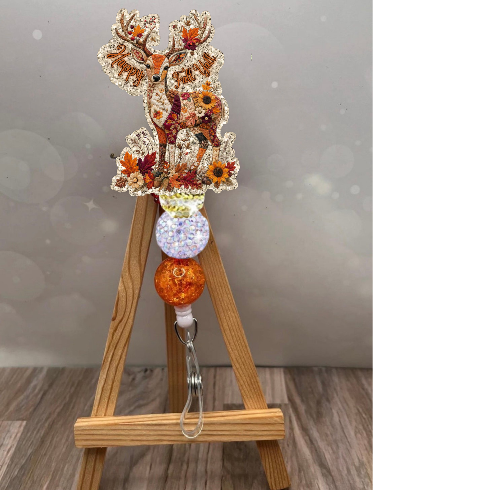 Patchwork deer badge reel with glitter background and autumn colors, perfect for fall-themed accessories.