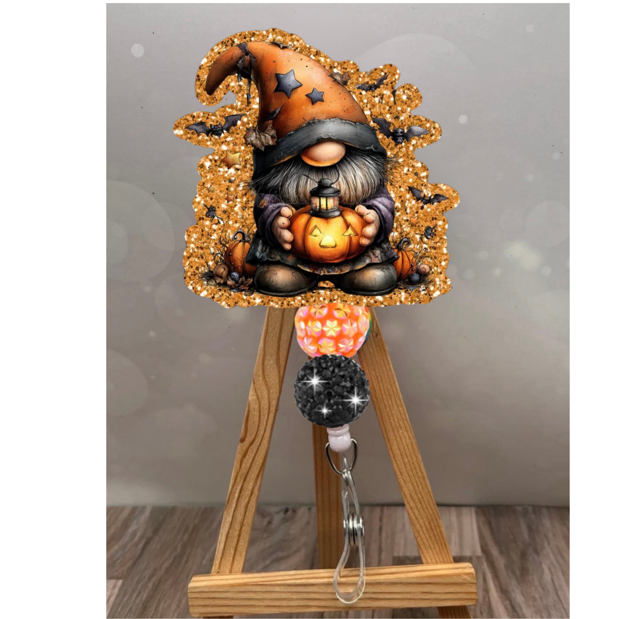 Whimsical Jack-o'-Gnome Keeper Badge Pull with glitter orange background, featuring a gnome and pumpkins, Halloween badge reel gnome.