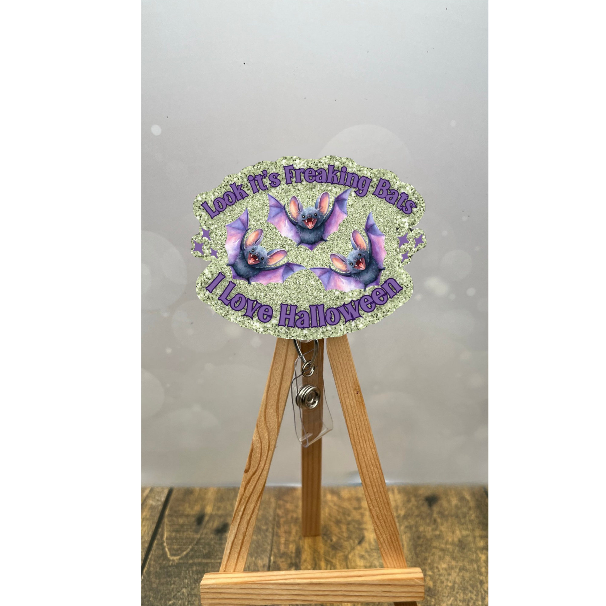Funny Halloween badge pull with bats and sparkly sage background, perfect for Halloween enthusiasts.