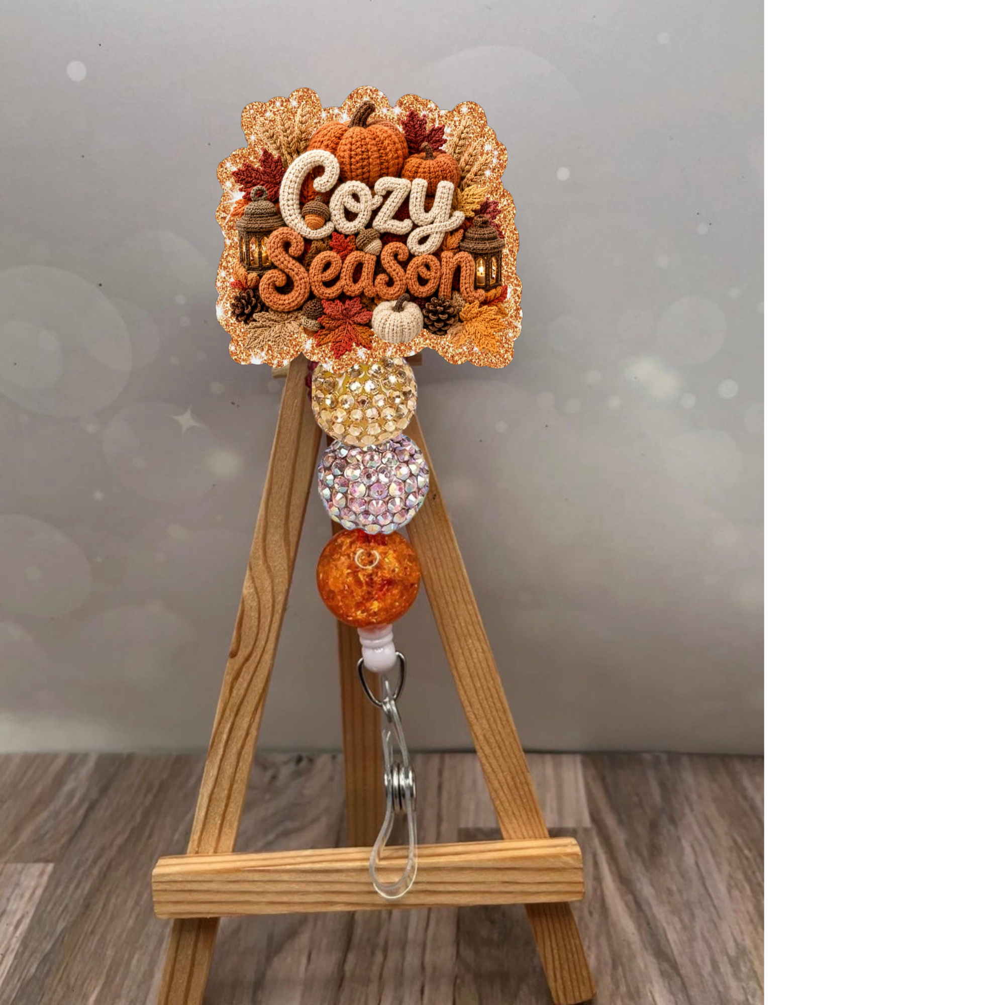 Cozy Season Badge Pull featuring an orange glitter background and decorative fall elements, perfect for lanyards.