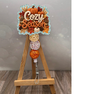 Cozy Season Badge Pull featuring a glitter background and decorative beads, perfect for fall-themed accessories.