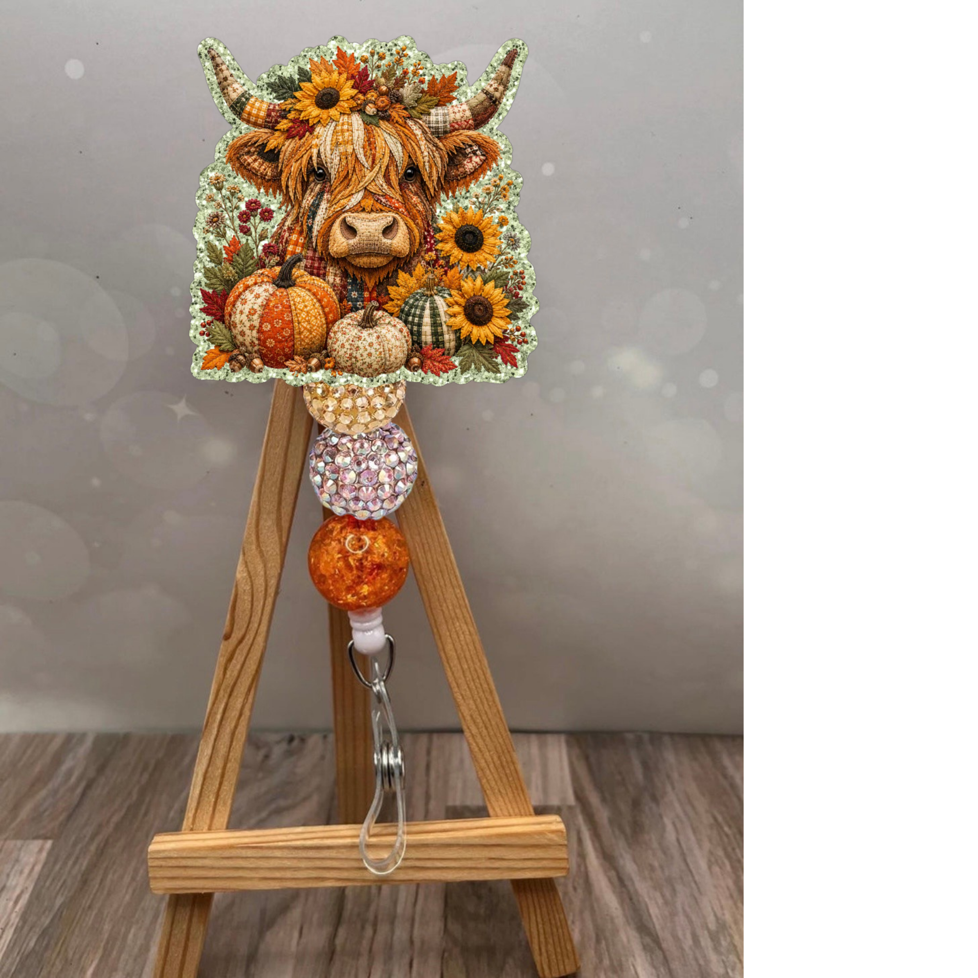Fall Highland Cow Badge Reel with sunflowers and pumpkins on glitter background, perfect workday accessory.