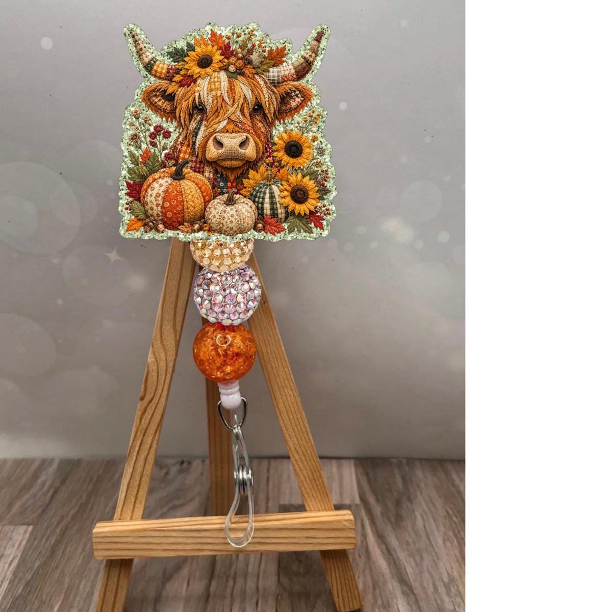 Fall Highland Cow Badge Reel with sunflowers and pumpkins on glitter background, perfect workday accessory.