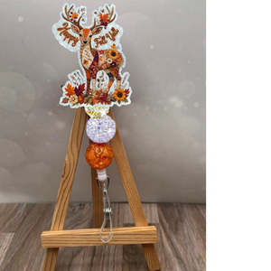 Patchwork deer badge reel with glitter background, featuring a charming deer and autumnal flowers, perfect for fall.