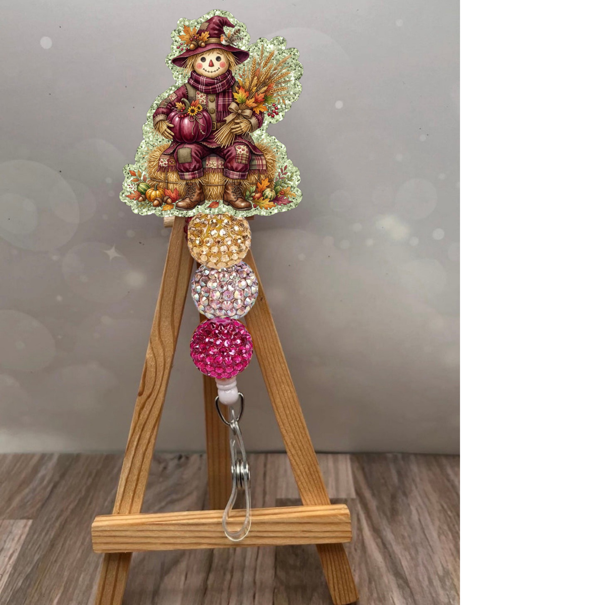Scarecrow badge pull featuring a classic design with glitter background in sage color, perfect for fall.