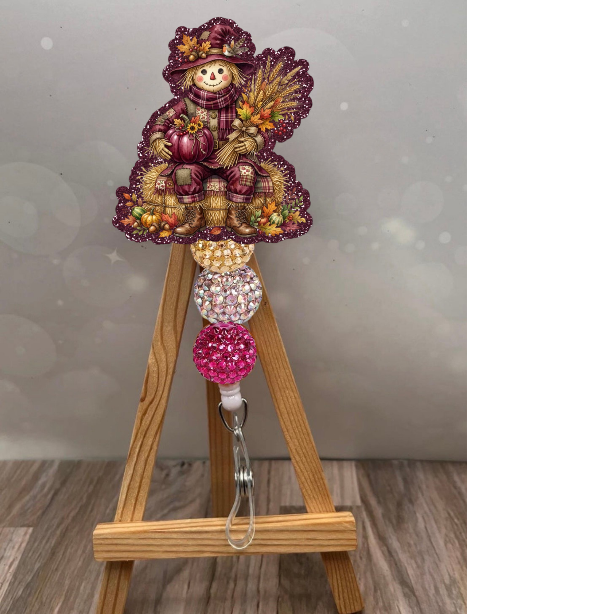 Adorable scarecrow badge pull with glitter background in plum color, perfect for adding fall charm to your workday.