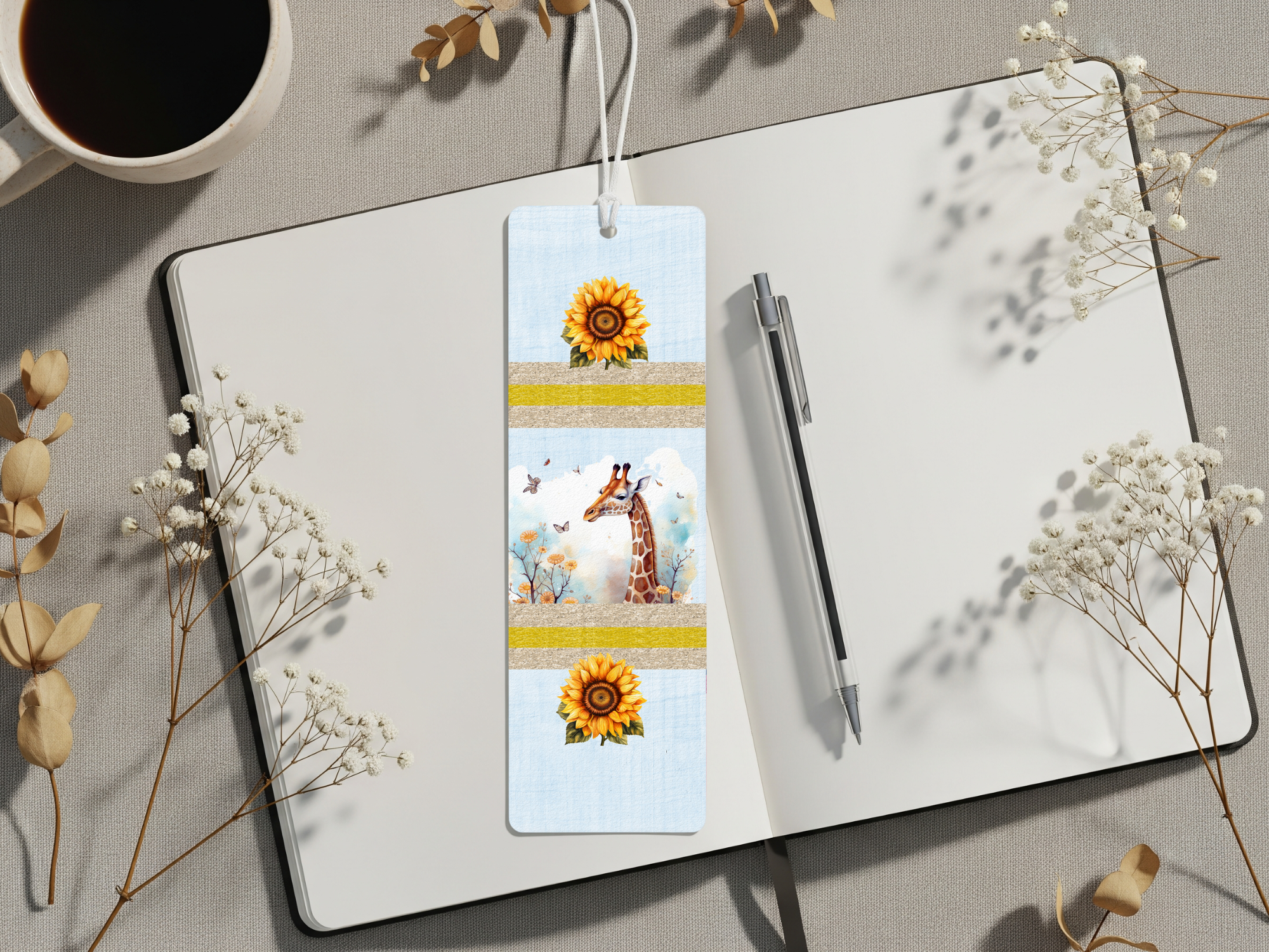 Giraffe metal bookmarks featuring sunflower designs on a notebook with coffee and flowers.