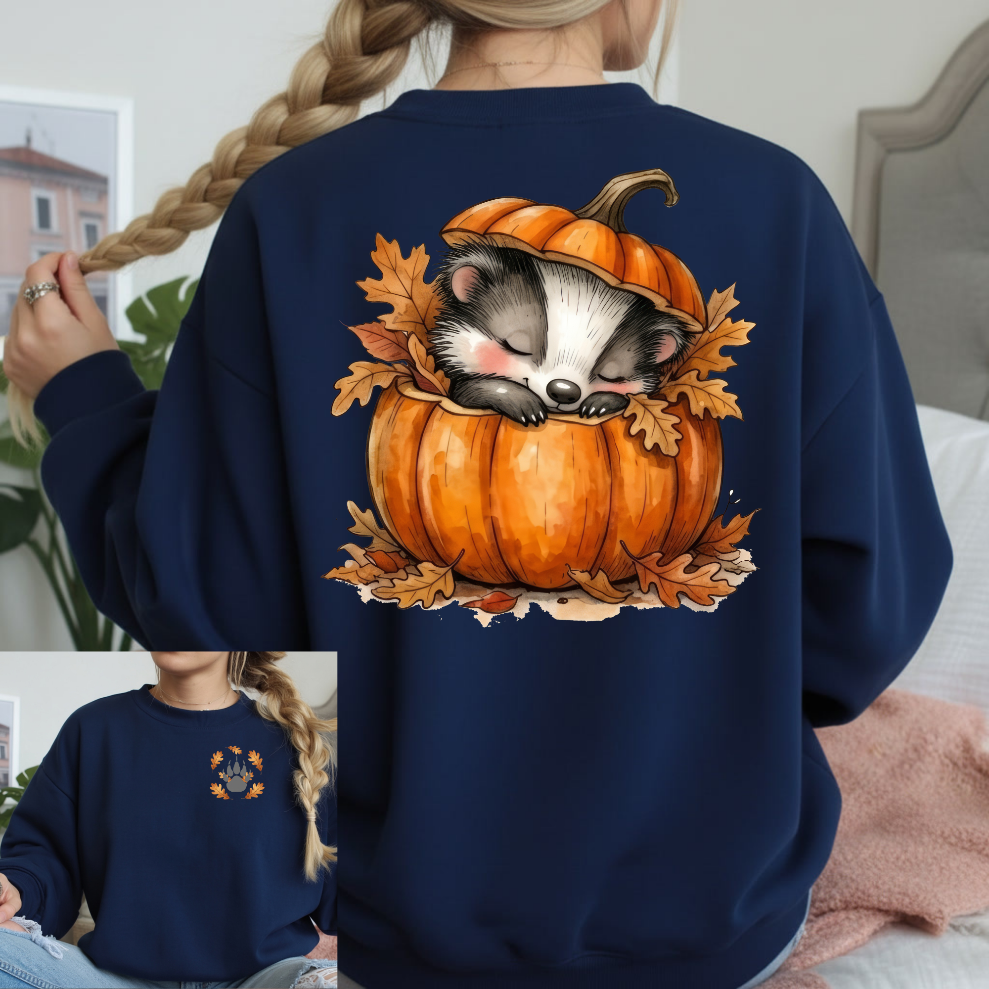 Cozy Badger graphic long sleeve tee featuring a badger sleeping in a pumpkin with autumn leaves on a navy background.