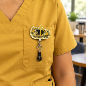 Badge pull lifestyle image on mustard-yellow scrubs
