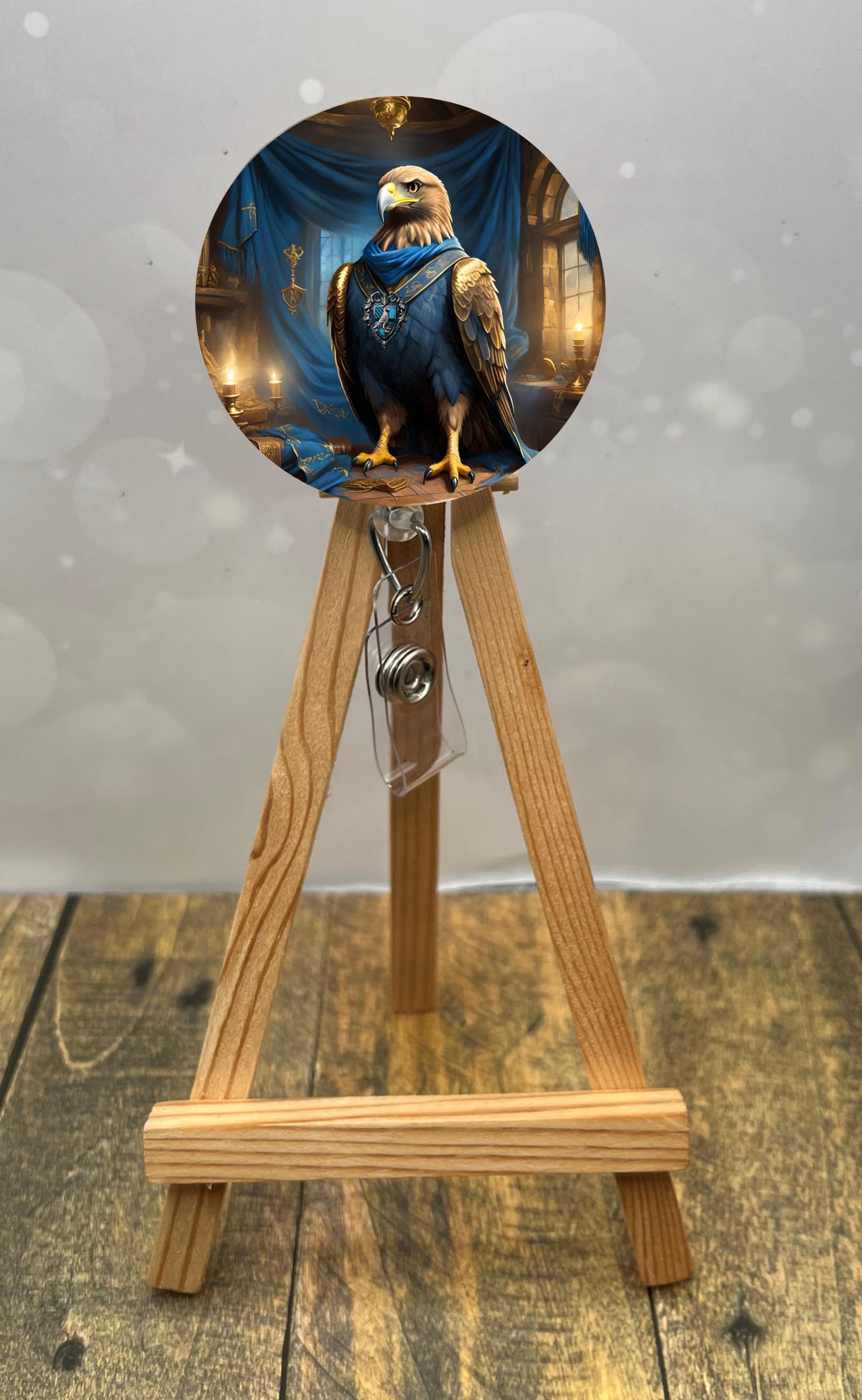 Eagle House badge pull with shimmer glitter displayed on a wooden easel featuring an eagle design.