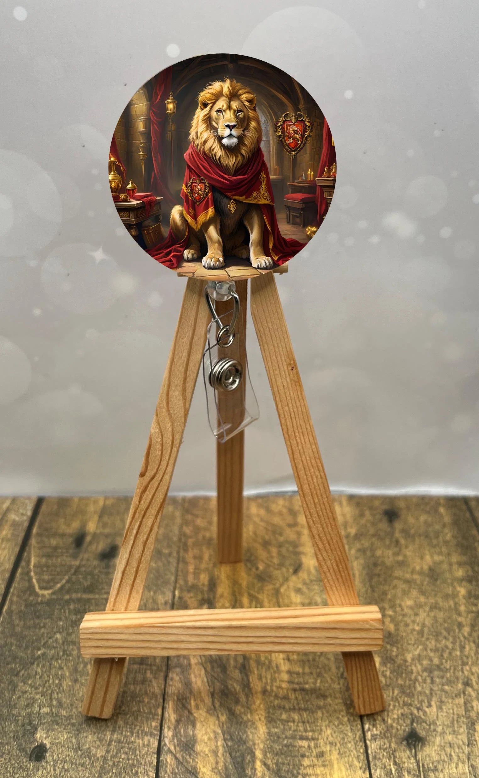 Gryffindor badge pull with glitter featuring a lion sitting majestically on a decorative stand.