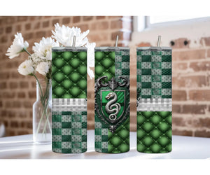 Slytherin stainless steel tumbler set with green and silver designs on a table with flowers.