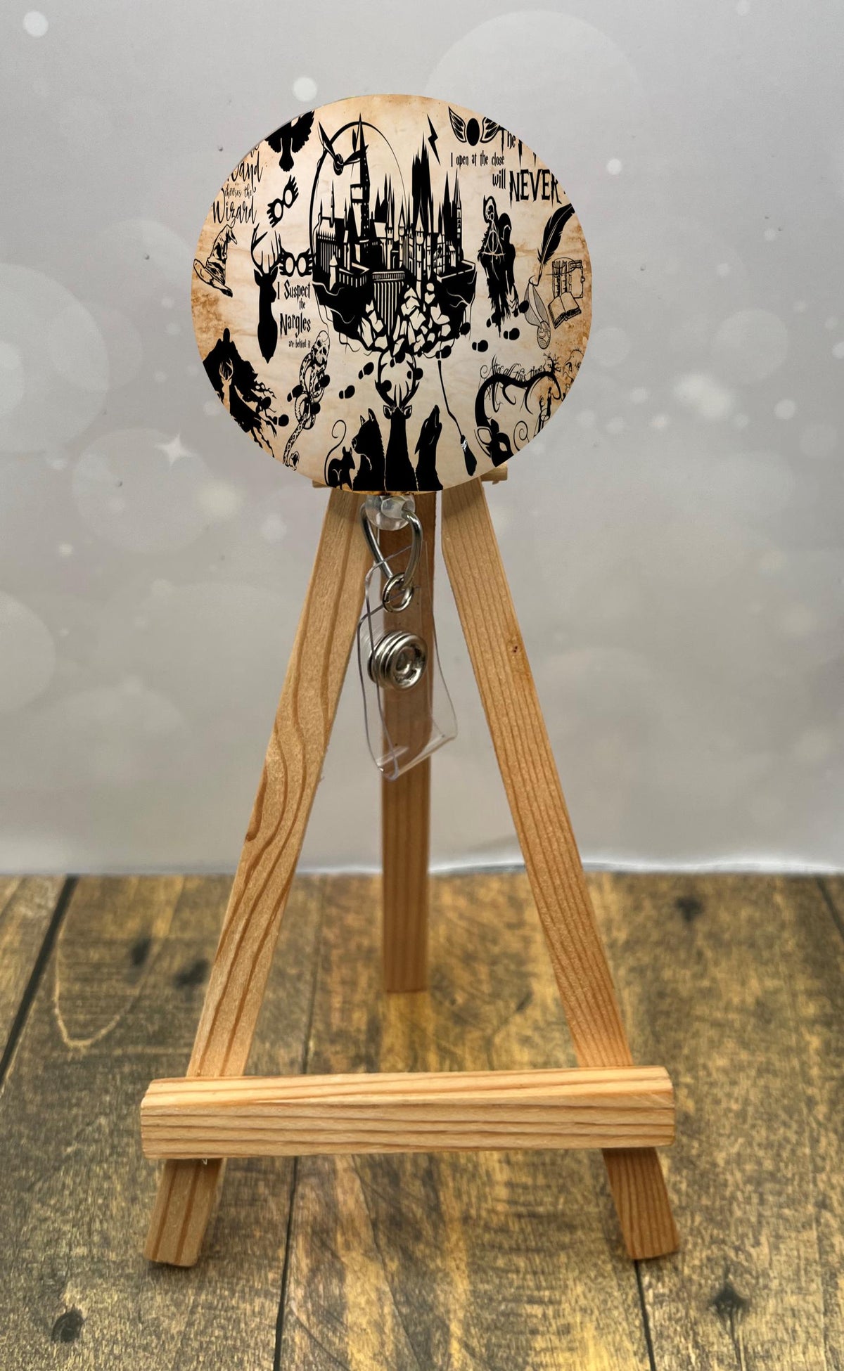 wizard badge pulls featuring whimsical wizard-themed artwork on a display easel.