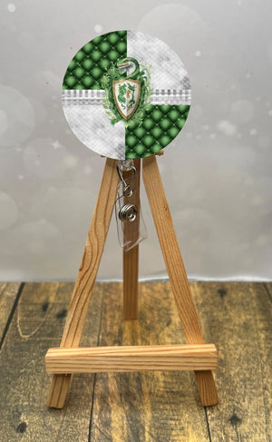 Slytherin badge pull with glitter featuring a green and silver design on a retractable badge holder.