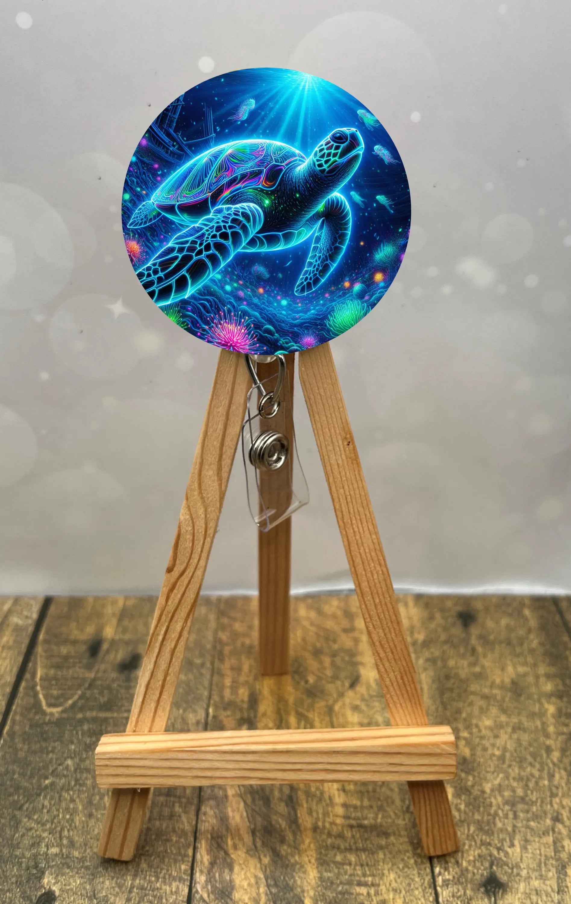 Colorful sea turtle badge pull design displayed on a wooden easel, showcasing ocean vibes for ID badges.