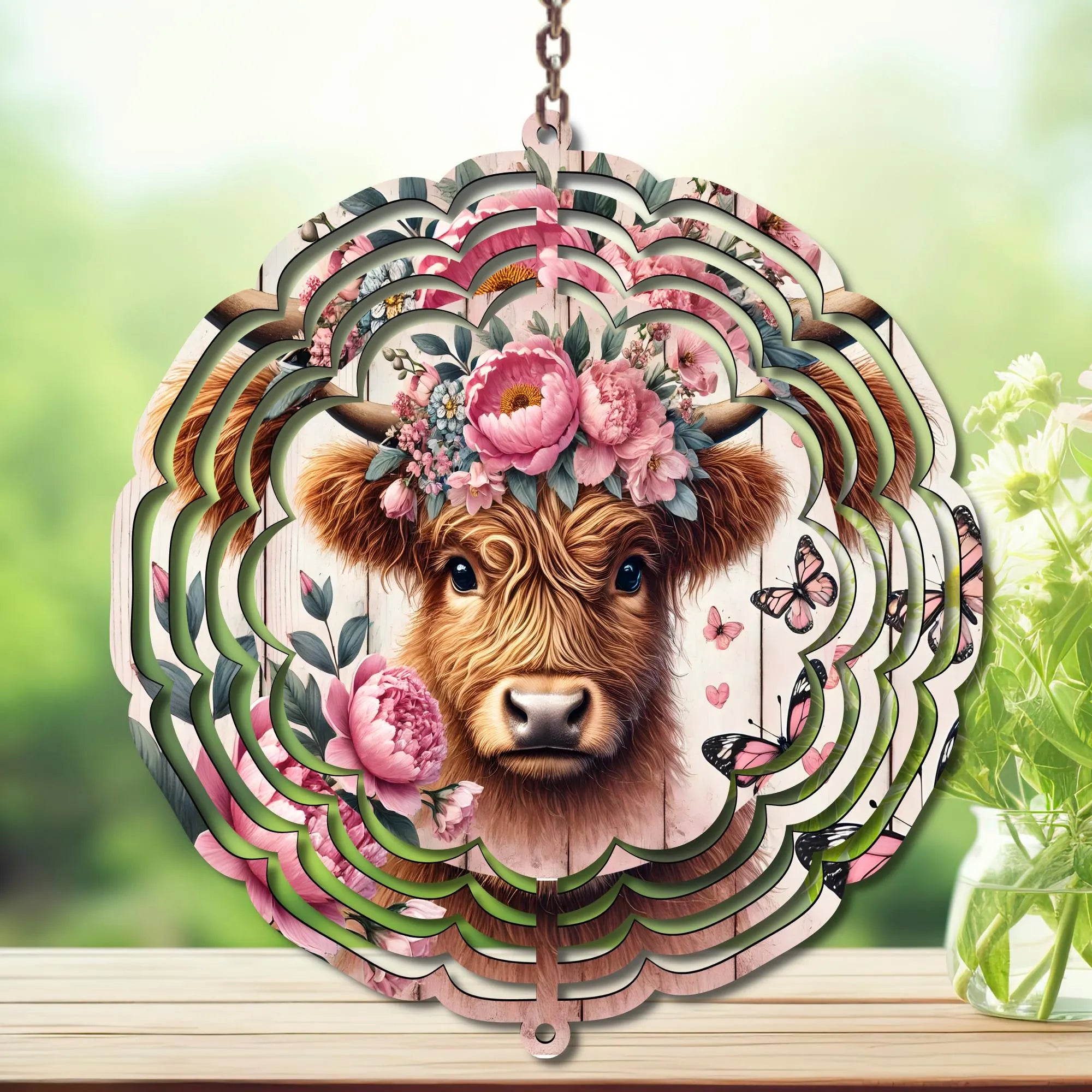 Highland cow wind spinner featuring a floral design with a cute cow and butterflies, perfect for outdoor decor.