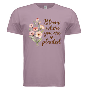 Inspirational graphic tee with floral design that says 'Bloom where you are planted' on a soft lavender shirt.