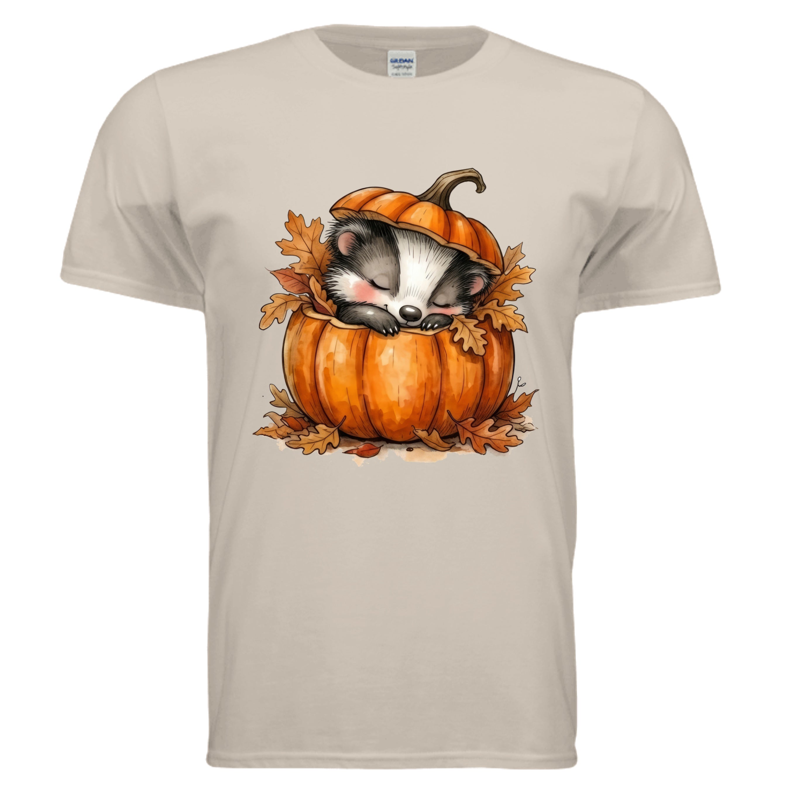 Cozy Badger graphic tee in sand color featuring a cute badger sleeping in a pumpkin with autumn leaves.