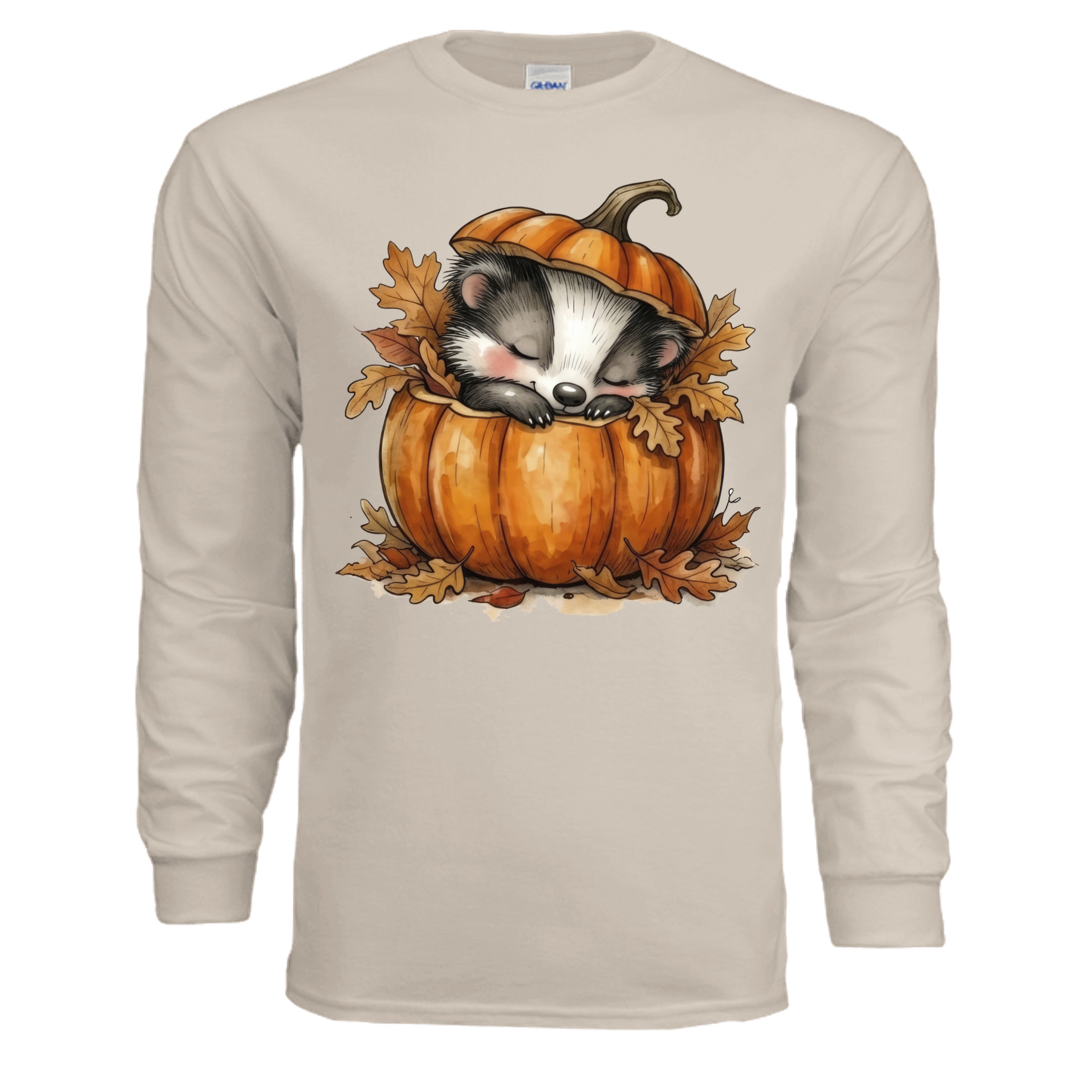 Cozy Badger Long Sleeve Tee in sand color featuring a cute badger sleeping in a pumpkin surrounded by autumn leaves.