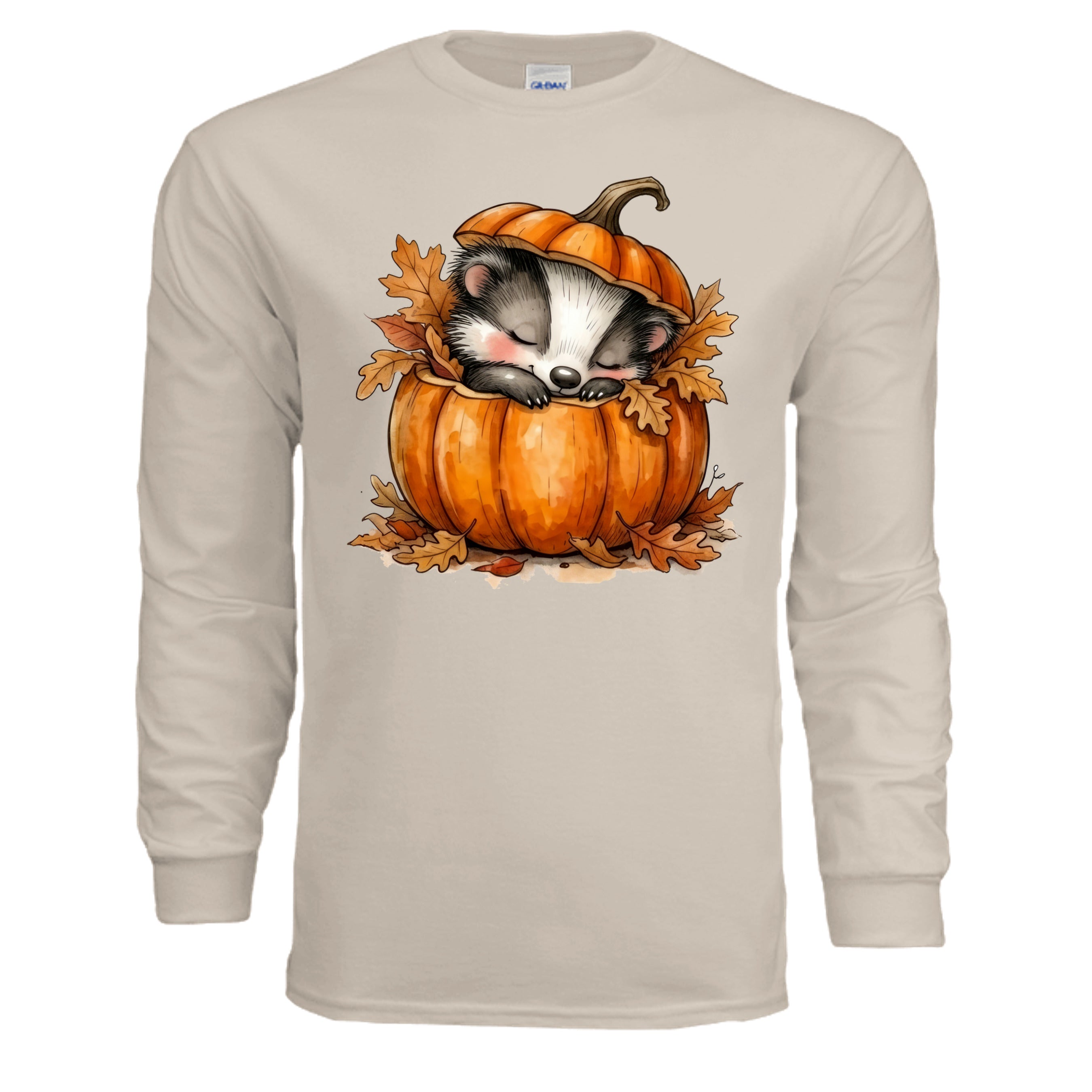 Cozy Badger long sleeve tee featuring a badger sleeping in a pumpkin with autumn leaves, in sand color.