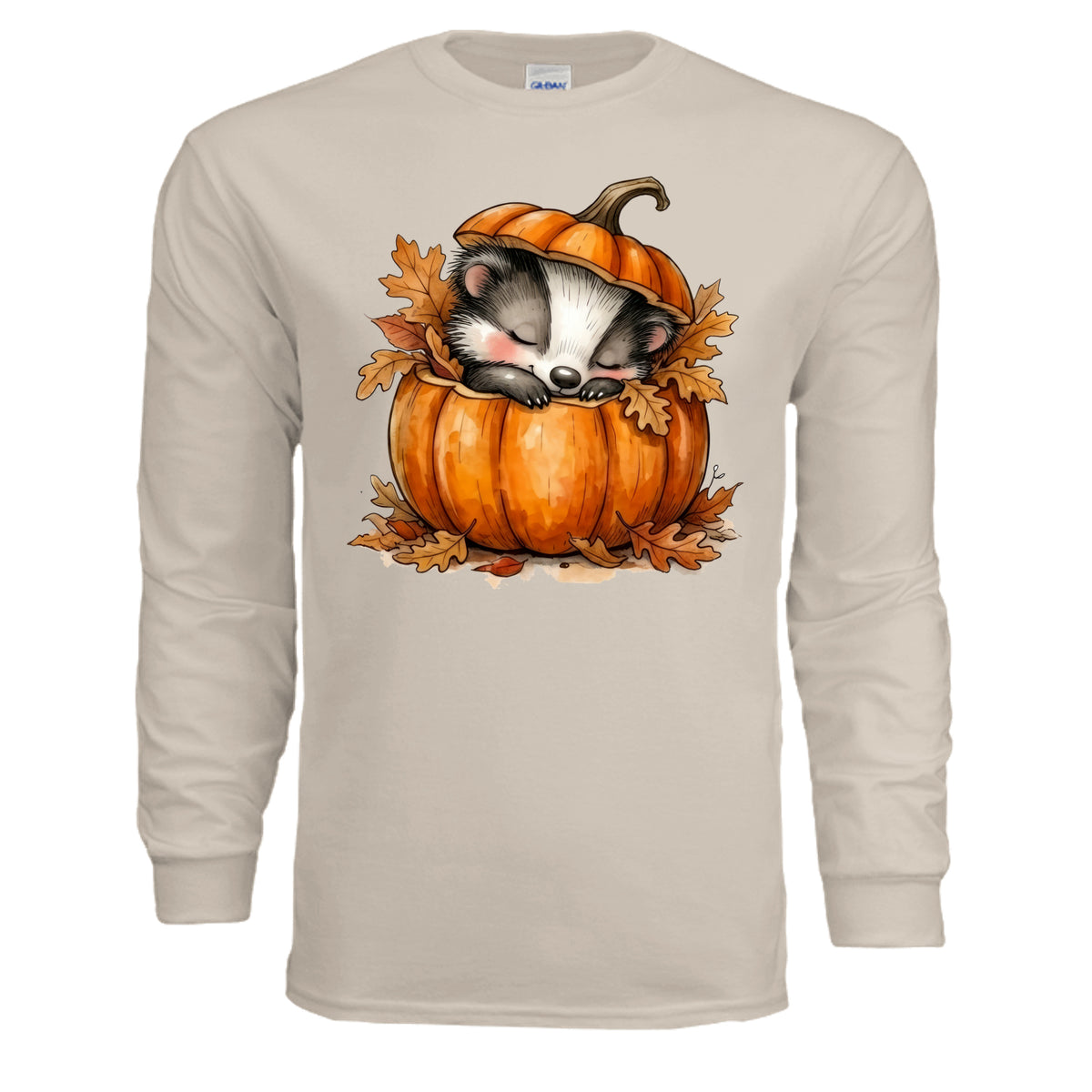Cozy Badger long sleeve tee featuring a badger sleeping in a pumpkin with autumn leaves, in sand color.