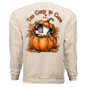 Graphic cozy sweatshirt with pocket featuring a cute sleeping animal in a pumpkin design.